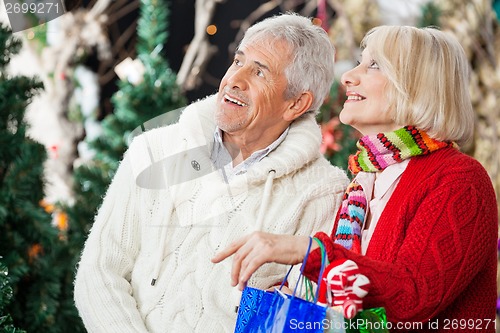 Image of Happy Couple Shopping At Christmas Store