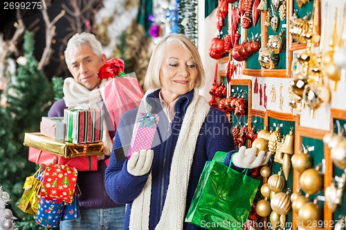 Image of Senior Woman Shopping Christmas Ornaments At Store