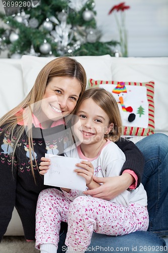 Image of Happy Mother And Daughter With Letter