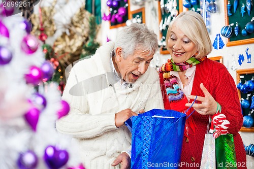 Image of Surprised Couple Looking Into Shopping Bag