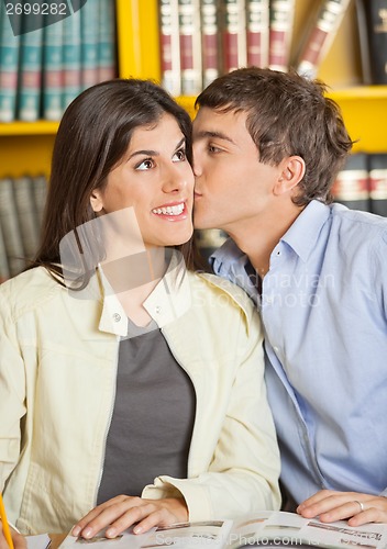 Image of Man Kissing Girlfriend In College Library