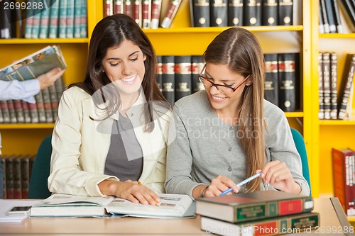 Image of Friends Studying At Table In Library