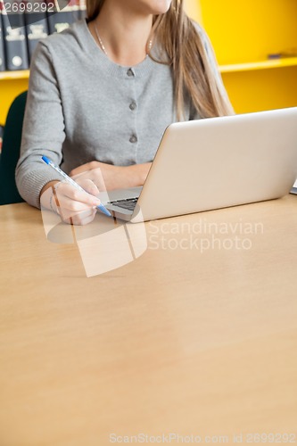 Image of Student With Laptop Sitting At Table In University Library