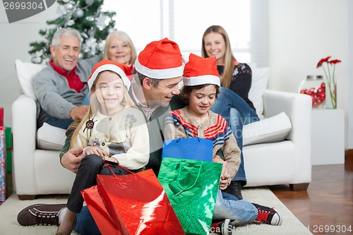 Image of Father And Children With Presents During Christmas