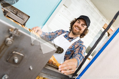 Image of Beekeeper Standing At Honey Extraction Plant