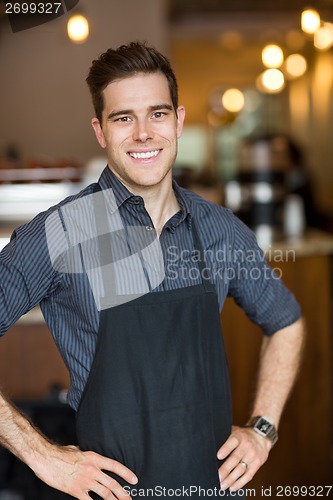 Image of Happy Male Owner Standing In Cafe