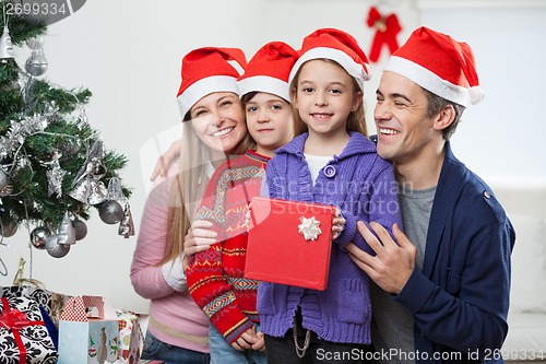 Image of Children And Family With Christmas Gift