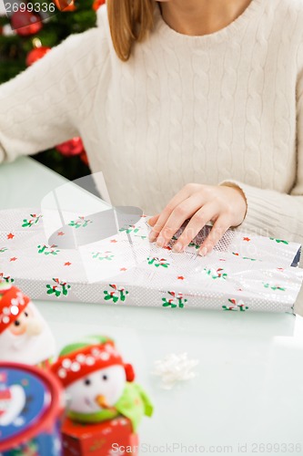 Image of Woman Packing Christmas Present