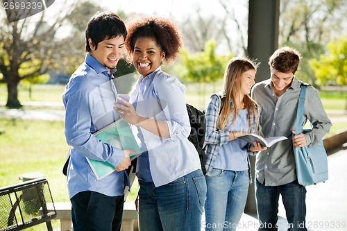 Image of Student Showing Cellphone To Friend At Campus