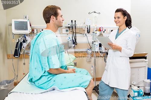 Image of Doctor With Clipboard Checking Patient's Report