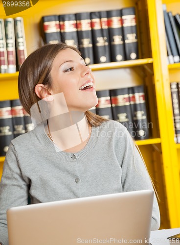 Image of Student With Laptop Looking Away In University Library