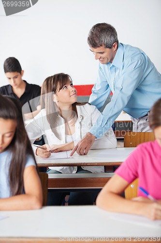 Image of Professor Pointing At Paper While Student Looking At Him