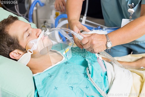 Image of Nurse Adjusting Endotracheal Tube In Patient's Mouth