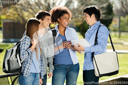 Image of Cheerful Students Looking At Friend In Campus