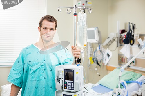 Image of Patient Holding Stand With Machine And Drip Bag