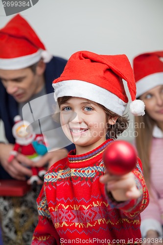 Image of Boy Showing Christmas Decoration At Home