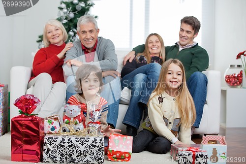Image of Family With Christmas Gifts In House