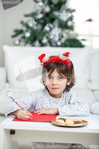 Image of Boy Wearing Headband Writing Letter To Santa Claus