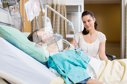 Image of Woman Looking At Man In Hospital