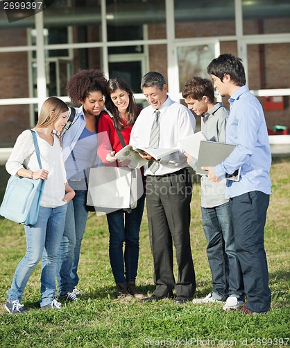 Image of Professor Teaching Lesson To Students On College Campus