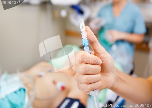 Image of Nurse Holding Syringe In Hospital