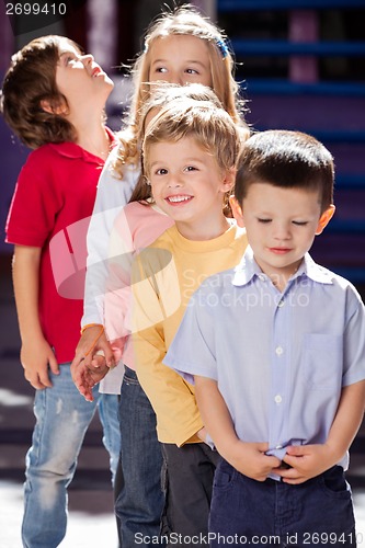 Image of Boy Standing With Friends In A Row At Kindergarten