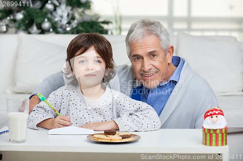 Image of Grandfather And Son With Envelope