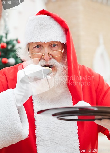 Image of Santa Claus Eating Cookies Outdoors