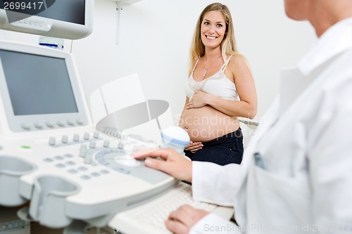 Image of Pregnant Woman Looking At Obstetrician