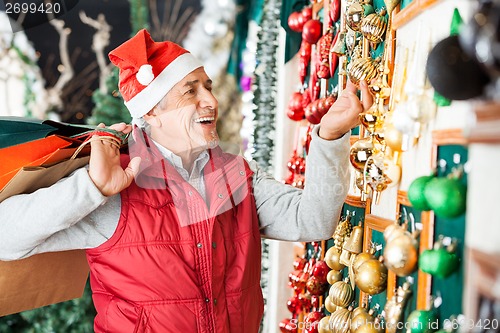 Image of Man Buying Christmas Ornaments At Store