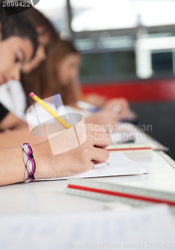 Image of High School Students Writing At Desk