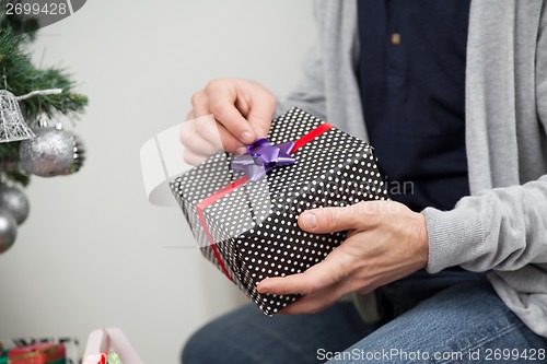 Image of Man Holding Christmas Gift