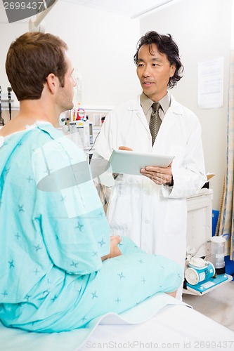 Image of Doctor Discussing Report Over Digital Tablet With Patient