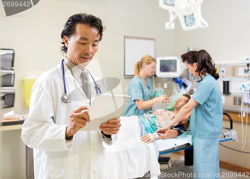 Image of Medical Team Treating Patient In Hospital