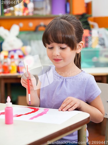 Image of Girl Painting At Desk In Art Class
