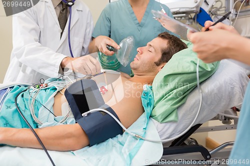 Image of Doctor And Nurses Examining Critical Patient