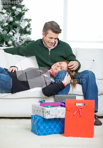 Image of Loving Couple With Christmas Gifts Relaxing At Home