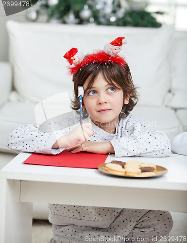 Image of Thoughtful Boy With Pencil And Cardpaper