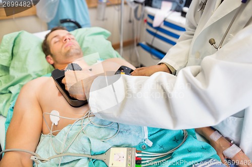 Image of Doctor Defibrillating Patient In Emergency