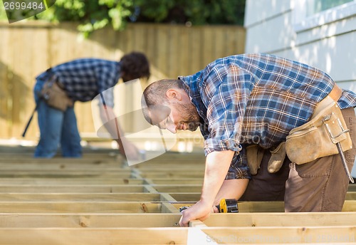 Image of Carpenters Working At Construction Site