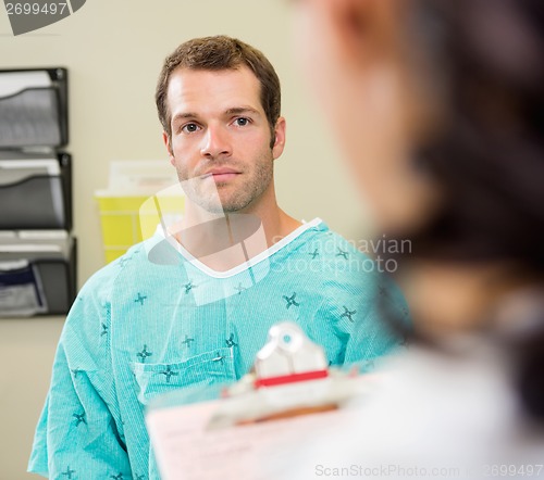 Image of Patient Looking At Doctor In Hospital