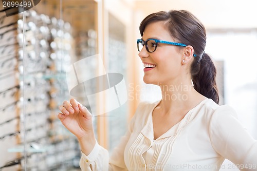 Image of Happy Woman Trying Glasses At Optician Store