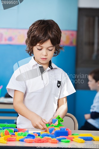 Image of Boy Playing With Colorful Blocks In Classroom