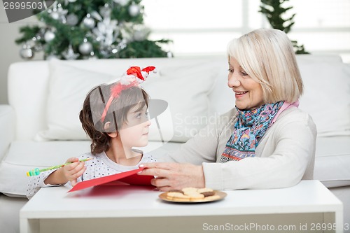 Image of Grandmother Assisting Boy In Writing Letter To Santa Claus