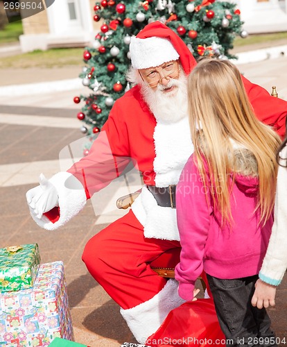 Image of Santa Claus Gesturing While Looking At Girl