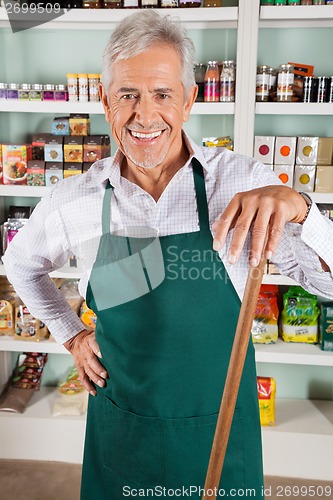 Image of Male Owner With Stick Standing In Store