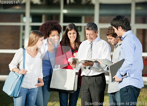 Image of Teacher Explaining Lesson To Students On College Campus