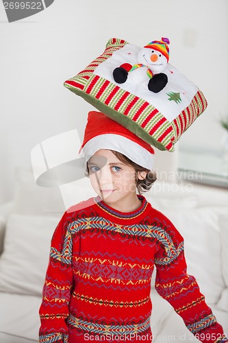 Image of Boy Balancing Cushion On Head During Christmas