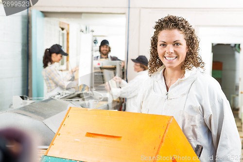 Image of Female Beekeeper With Stacked Honeycomb Crates