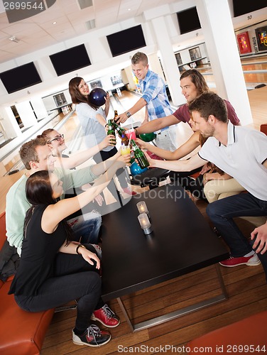 Image of Friends Toasting Drinks in Bowling Club